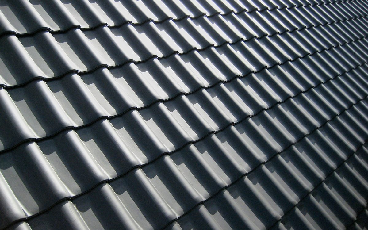 Freshly coated dark grey roof tiles